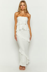 Front view of a white fitted maxi skirt with a long diagonal ruffle detail