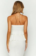 Rear view of a white strapless top with two tiered ruffles at the back