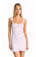 A delicate light pink satin mini dress- featuring a softly ruched sweetheart neckline and subtle lace-trimmed shoulder straps- perfect for a romantic or semi-formal occasion.