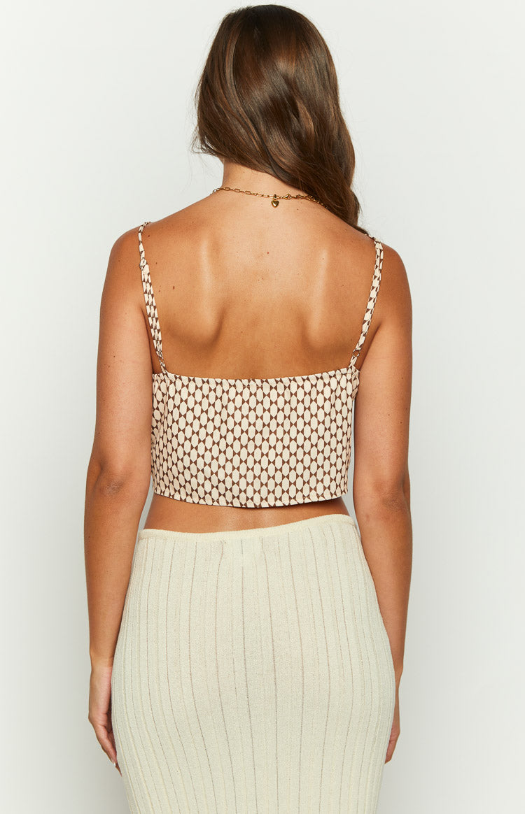 Rear view of the beige crop top with a brown oval geometric pattern and delicate spaghetti straps