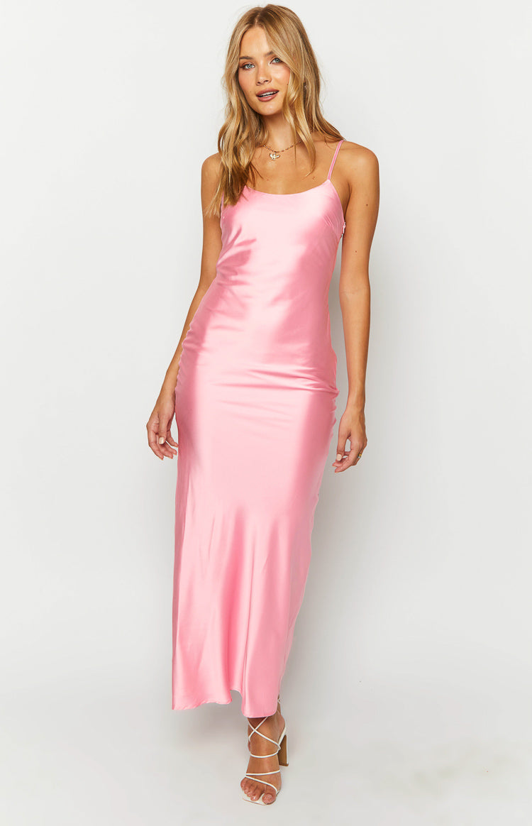 Front view of a pink satin maxi dress, showing the fitted bodice and flowing skirt with delicate spaghetti straps