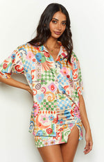 Front view of a vibrant patchwork print satin shirt with an open camp collar and short sleeves