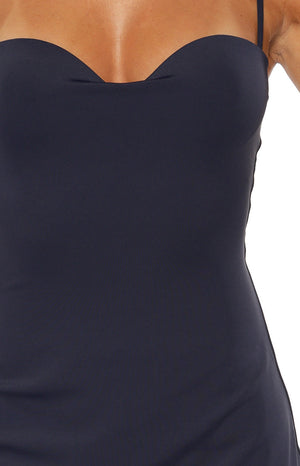 Close-up of the navy mini dress showing the sweetheart neckline and thin spaghetti strap