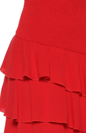 Close-up of the red smocked bodice texture and the layered ruffles of the maxi dress skirt