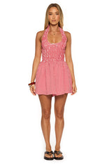 Front view of a red gingham halter playsuit with a smocked bodice and gathered mini shorts