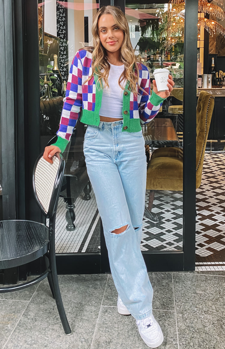 Distressed light blue wide leg jeans with rips on both knees