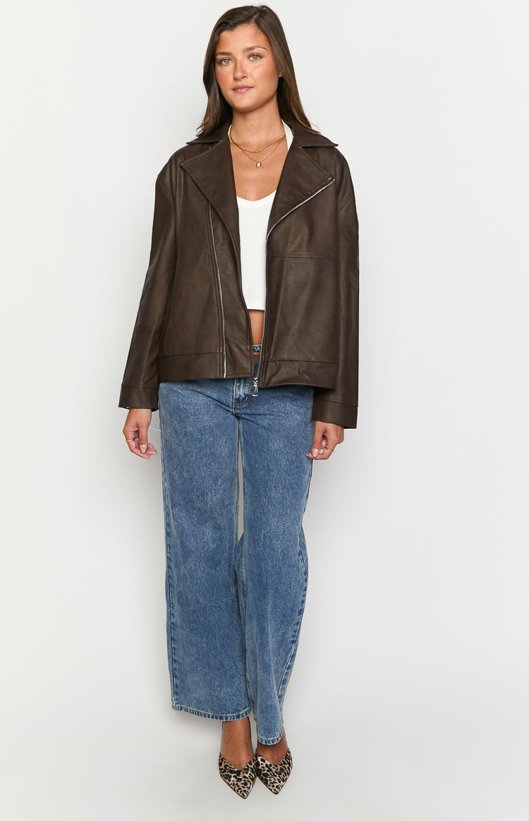 Front view of an oversized chocolate brown PU biker jacket worn open, showing wide lapels and silver zipper