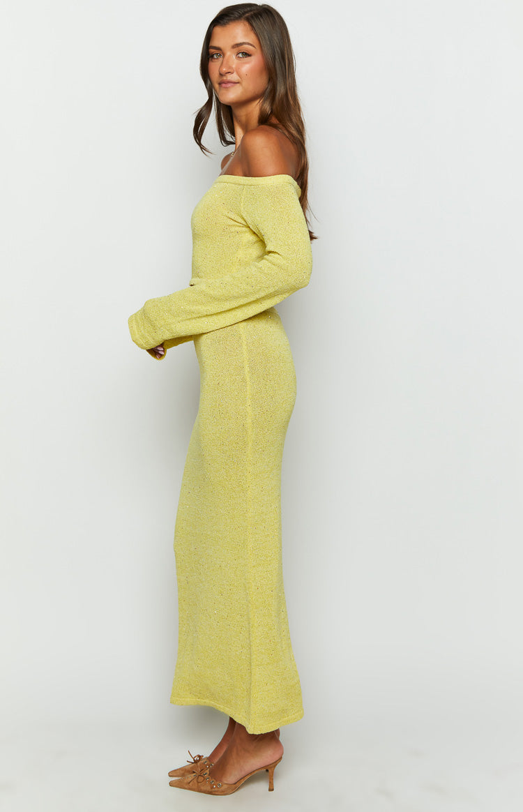 Side view of a yellow knit maxi skirt, showing its fitted silhouette and subtle flecked texture
