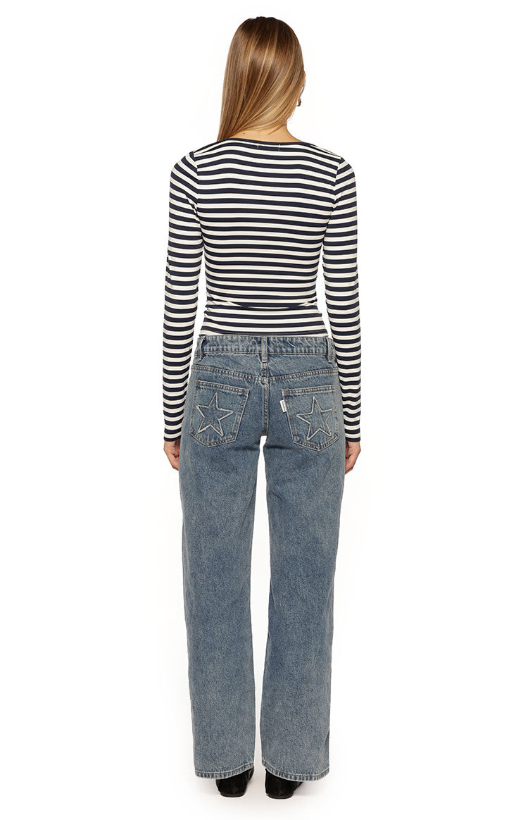 Rear view of the fitted navy and white striped long sleeve top with a subtle scoop back