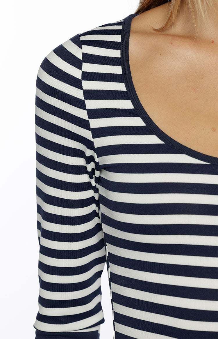 Close-up of the scoop neckline and shoulder of a navy and white striped long sleeve top