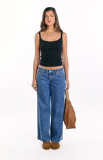 Mid wash blue low rise wide leg denim jeans with a relaxed fit and classic five-pocket styling