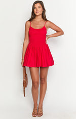 Front view of a red mini dress with a smocked bodice and V-shaped waistline