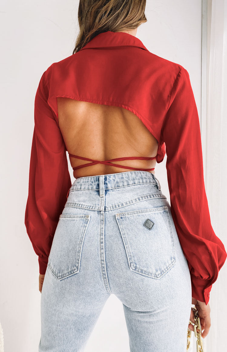 Rear view of a red collared crop top with a wide open back and crisscross tie-back straps