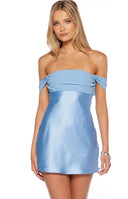 Model wearing a baby blue satin mini dress with a stunning contrast chiffon bust and off shoulder neckline. This elegant mini dress is perfect for homecoming and semi formal occasions