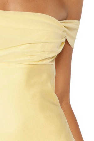 Close-up of the yellow off-shoulder neckline with gathered fabric detail on the bust