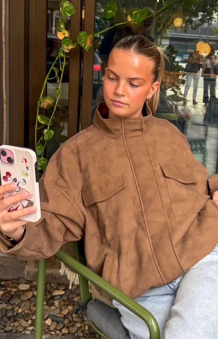 Brown oversized suedette jacket with a funnel neck and two chest flap pockets
