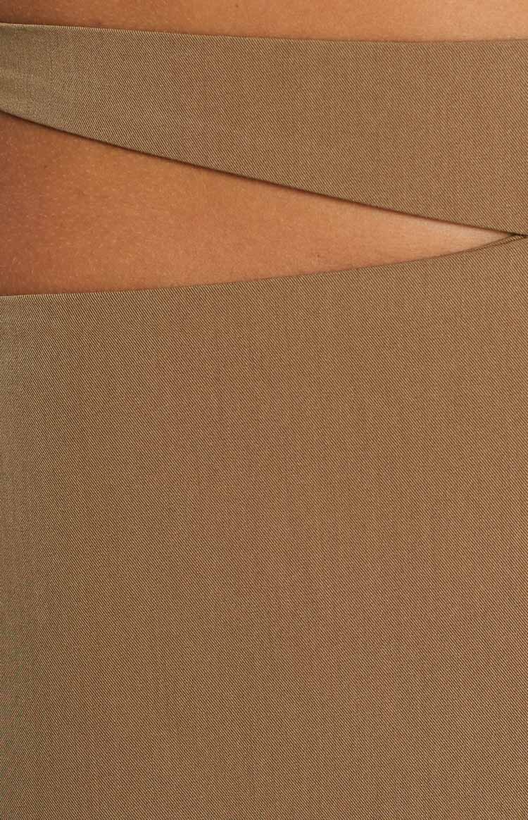Close-up showing the diagonal cutout detail on the khaki twill mini skirt