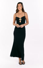 Black maxi dress featuring a central cutout with gold sequin hibiscus trim and a ruffled hem