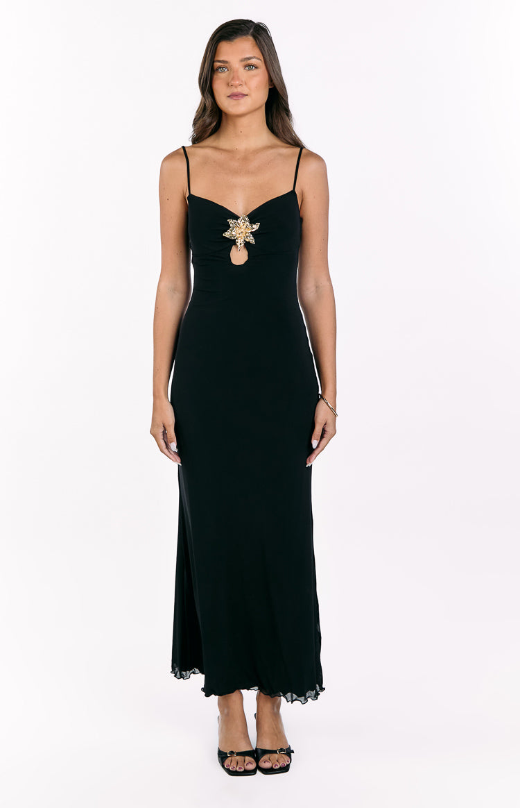 Black maxi dress with gold hibiscus trim, bust cutout, thin spaghetti straps, and ruffled hem