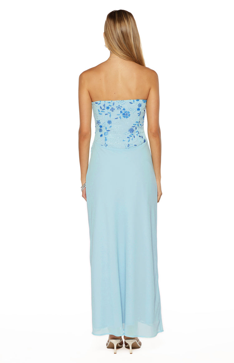 Rear view of the light blue strapless maxi dress with a beaded floral bodice and flowing skirt