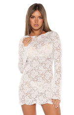 White floral lace mini dress featuring a wide scoop neckline, long sleeves, and sheer fabric