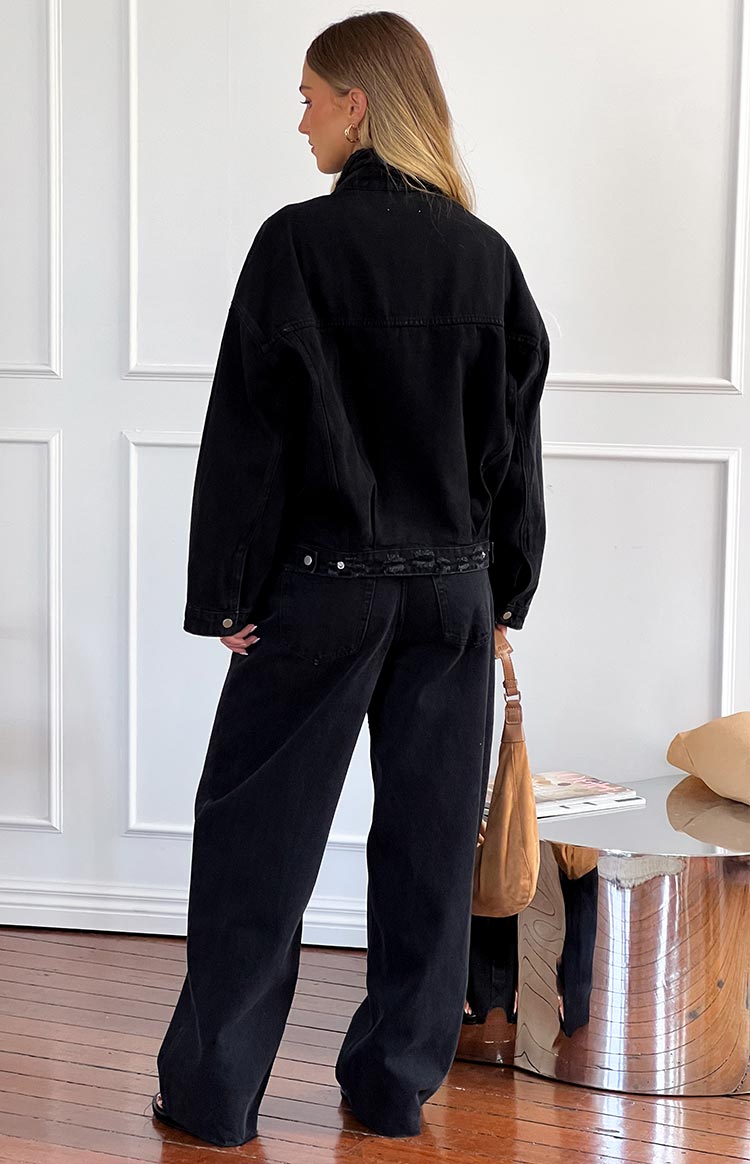 Rear view of black wide leg boyfriend jeans showing back pockets and a relaxed fit
