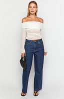 girl wearing dark wash low rise jeans with raw hem details 