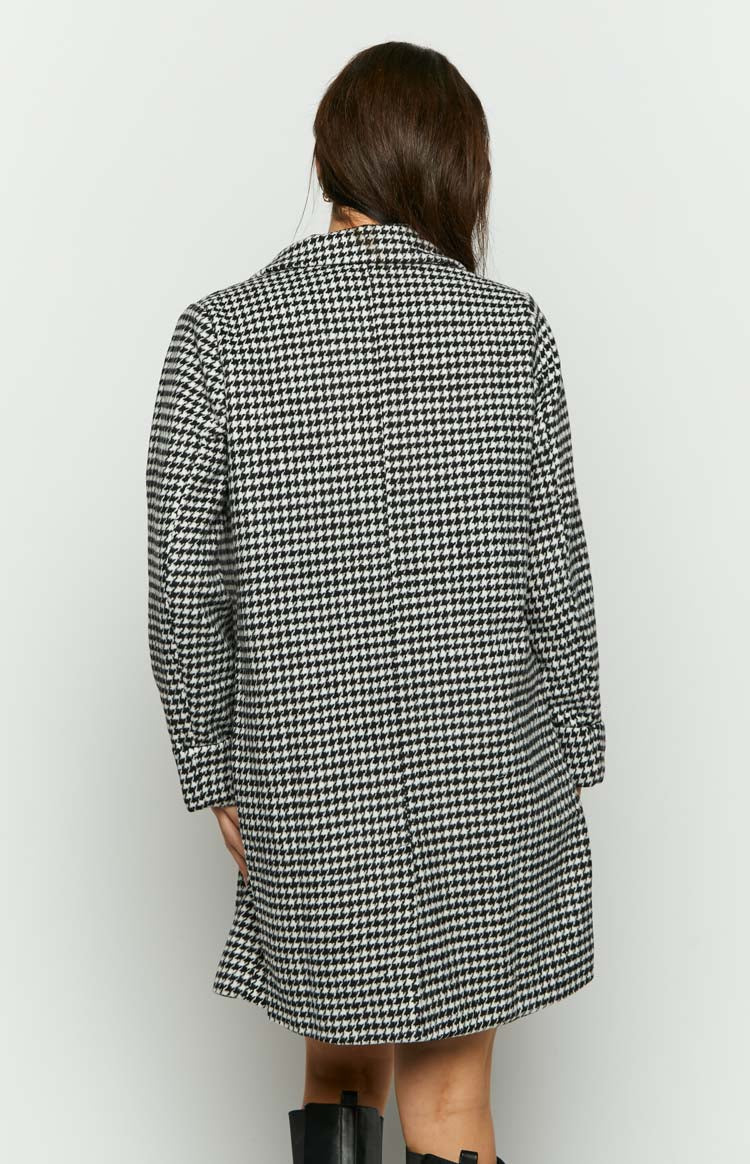 Rear view of a black and white houndstooth check longline jacket with a relaxed fit