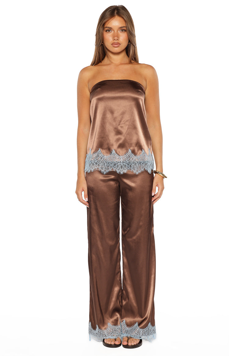 Front view of a brown satin strapless top with light blue scalloped lace trim at the hem