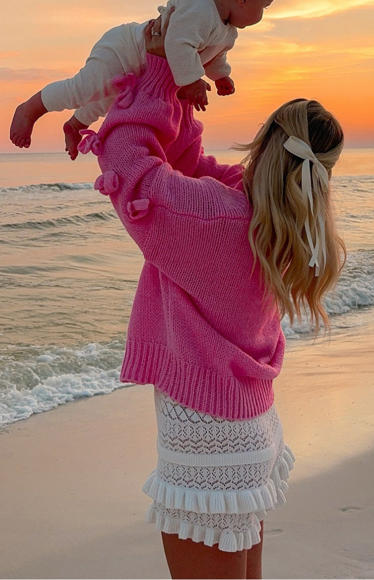 Beginning Boutique Short and Sweet Pink Knit Jumper bright pink chunky knit jumper with ribbed high neck long sleeves and bow details on sleeves