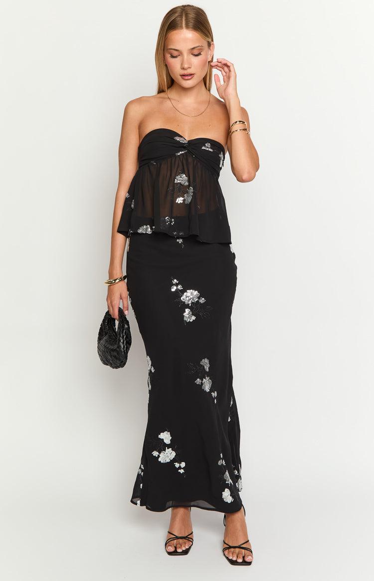 Black maxi skirt with scattered silver floral embroidery and a subtle flared hem