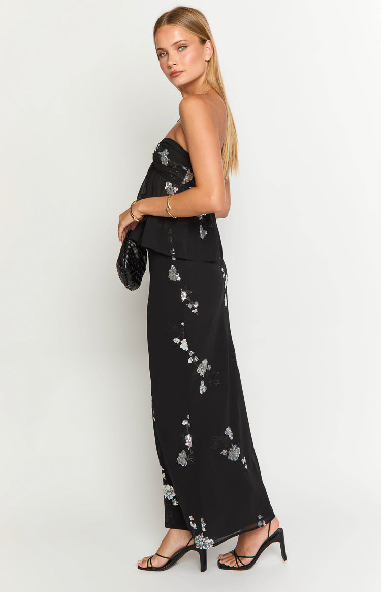 Side view of a black maxi skirt with silver sequin floral embellishments
