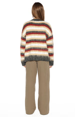 Back view of the red, white, beige, and grey striped oversized sweater with a fluffy knit