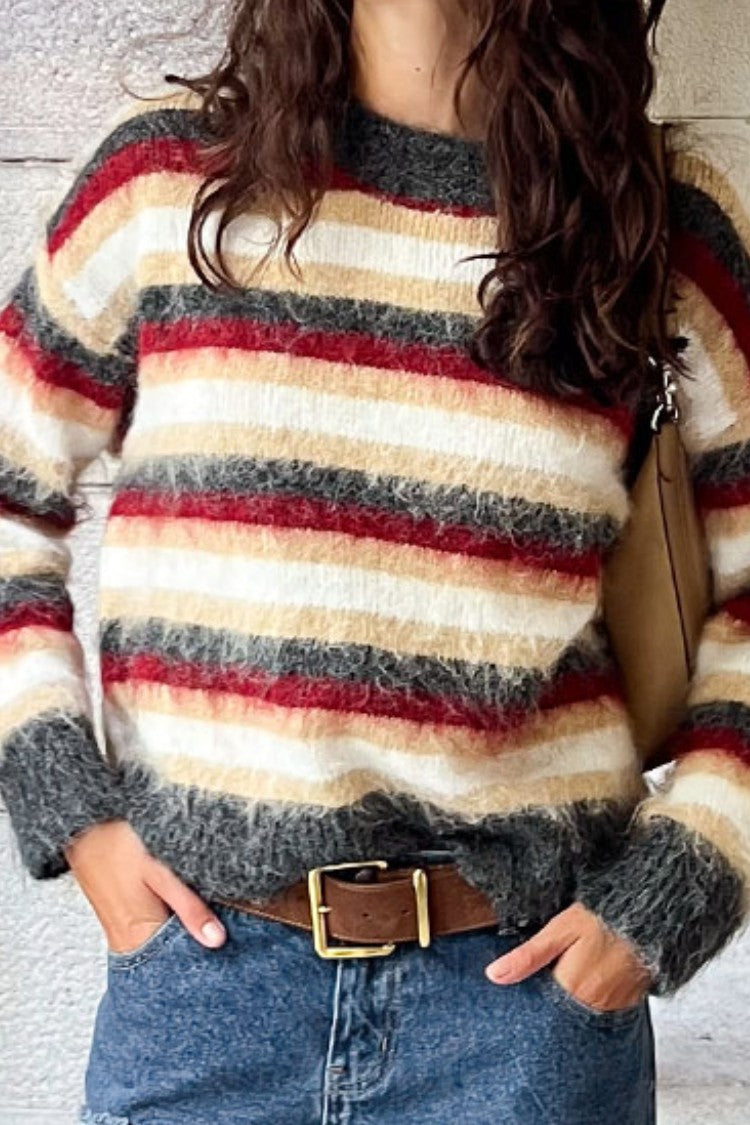 Close-up of the fluffy multi-stripe oversized sweater showing the textured knit and ribbed cuffs