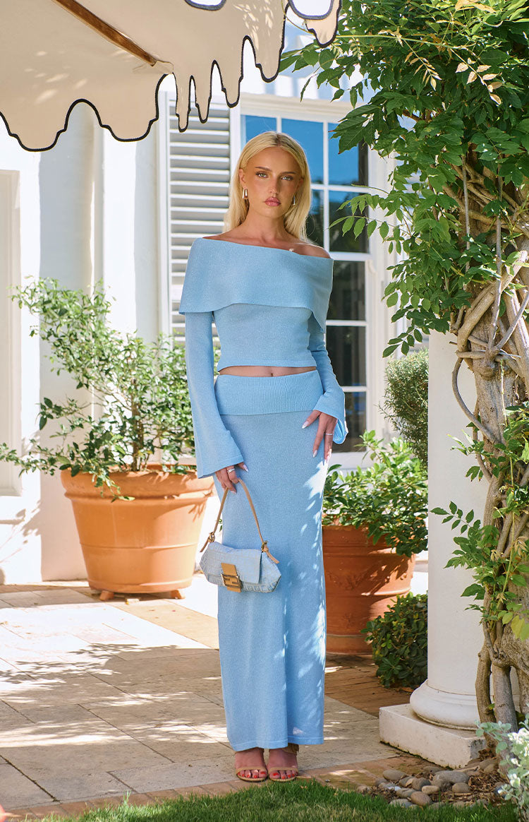 Front view of a light blue knit maxi skirt with a fitted straight silhouette and ribbed waistband