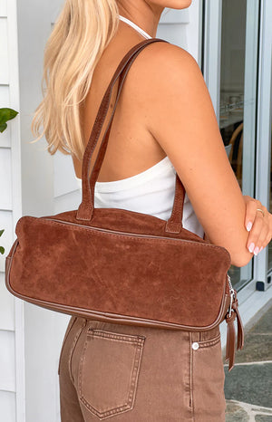 Beginning Boutique Sloane Brown Suede Baguette Bag brown suede baguette bag with twin shoulder straps and piping detail