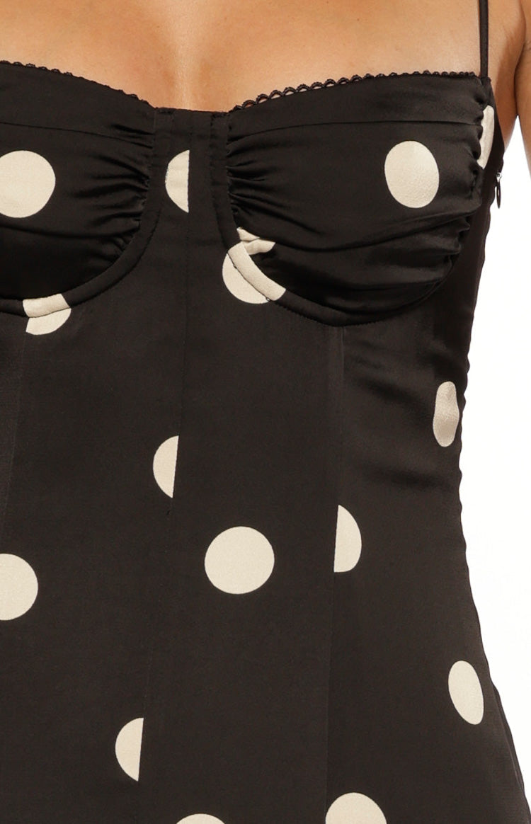 Close-up of the black satin spot dress bodice with ruched bust, sweetheart neckline, and scalloped lace trim
