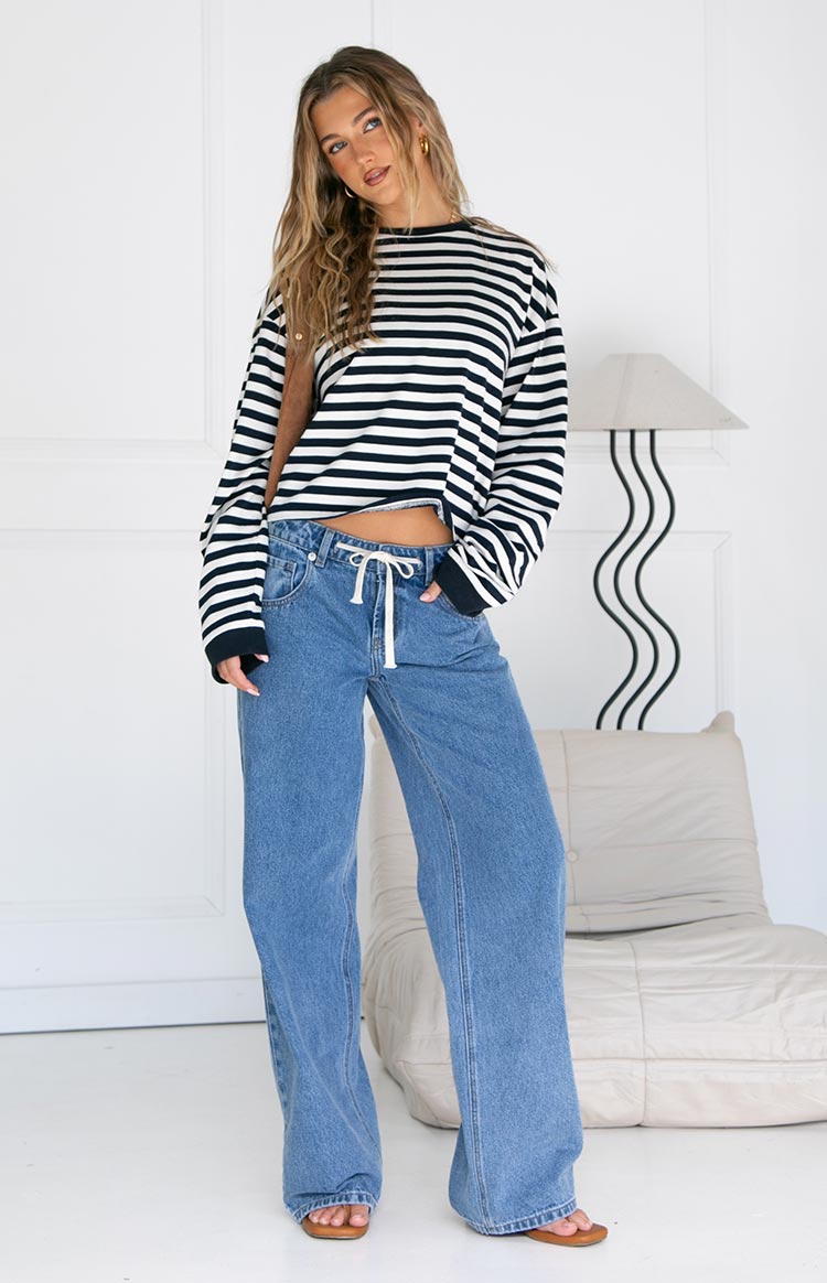 Full view of the navy and white striped long sleeve top with a crew neck, long cuffed sleeves, and relaxed fit