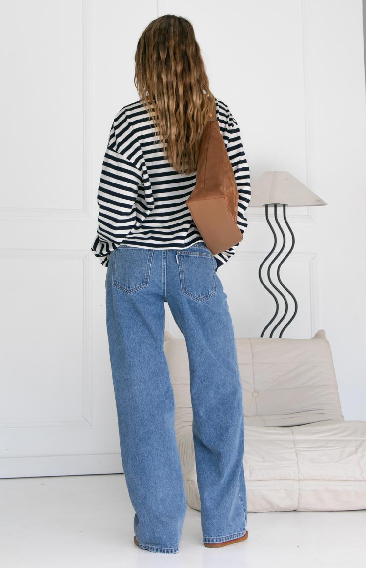 Rear view of the navy and white striped long sleeve top, showing its relaxed fit and straight hemline