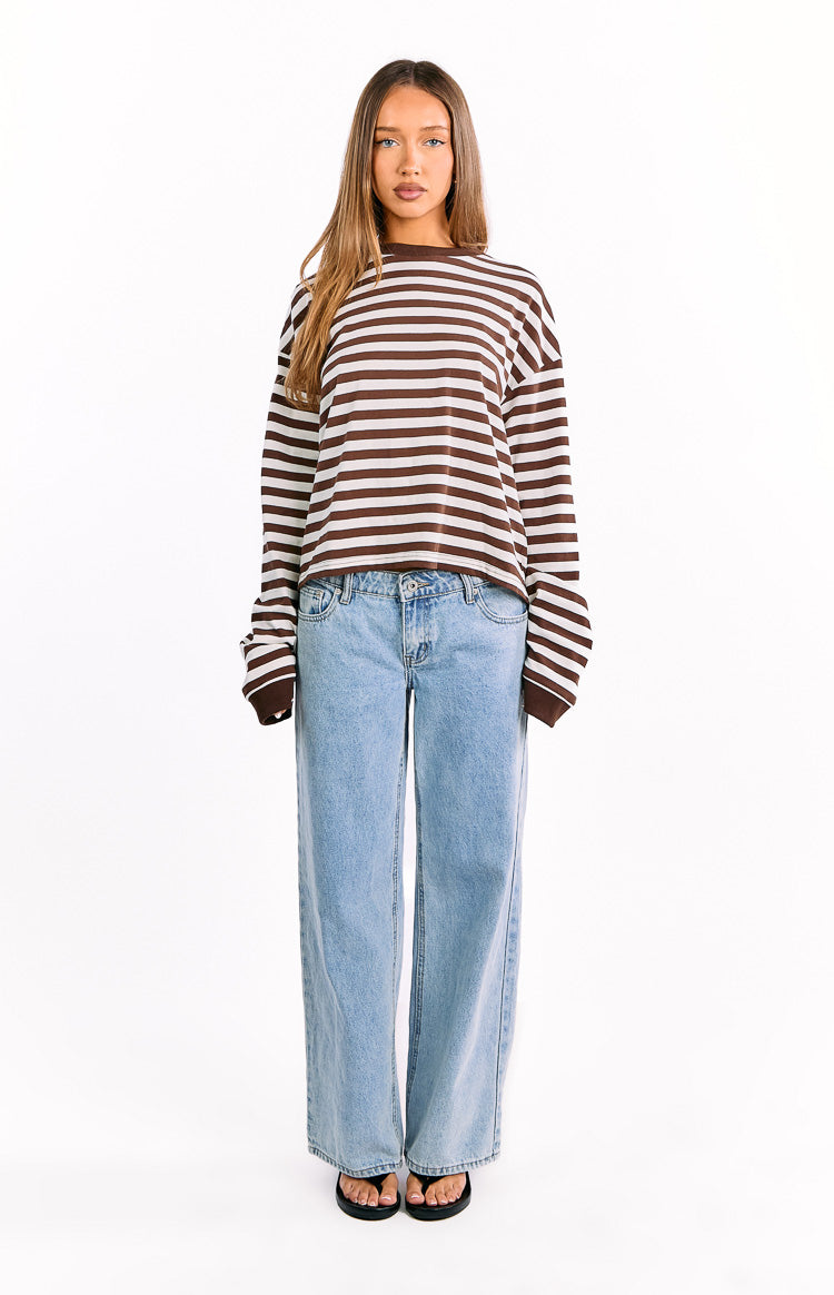 Front view of a chocolate brown and white striped long sleeve top featuring a relaxed fit and wide cuffed sleeves