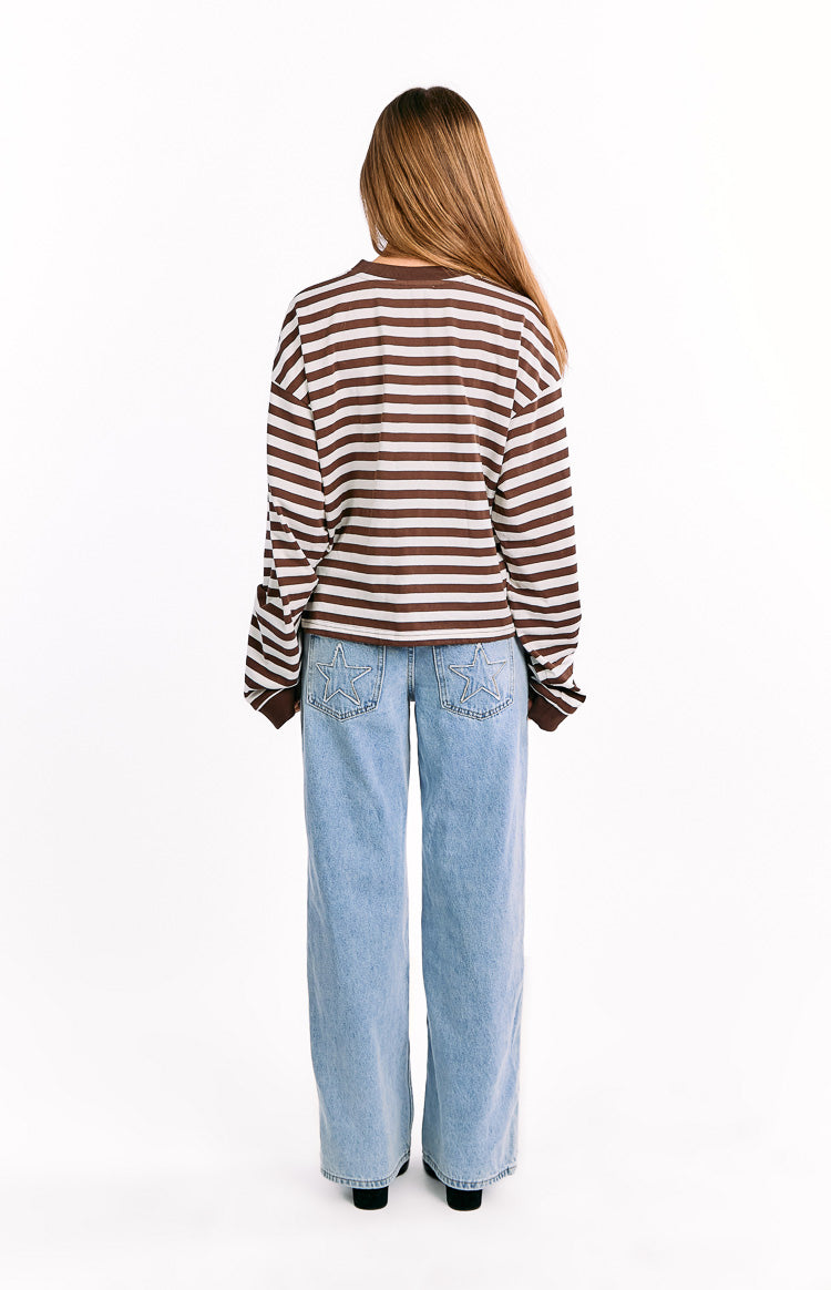 Rear view of a chocolate and white striped long sleeve top with a relaxed fit and cropped hem