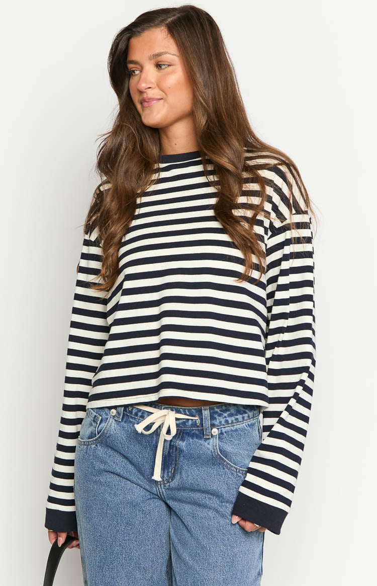 Relaxed fit navy and white striped long sleeve top with a cropped hem and dark ribbed cuffs