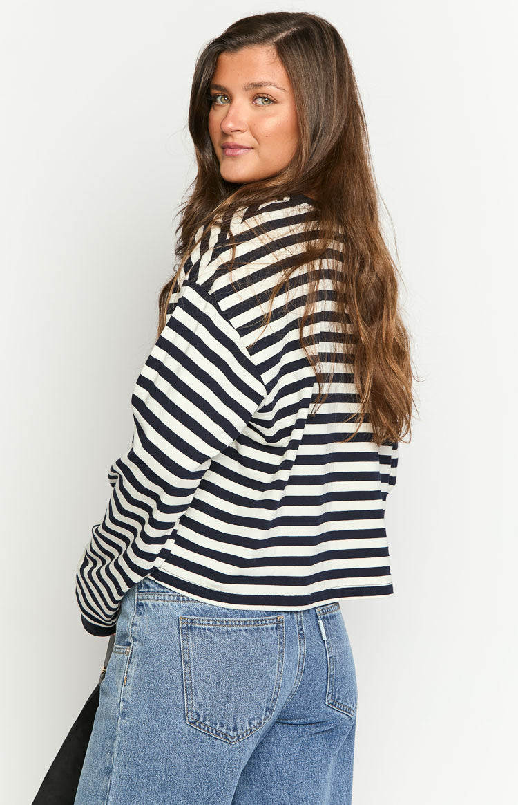 Rear view of a navy and white striped long sleeve top with a relaxed fit and cropped hem