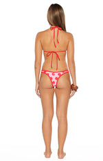 Rear view of a pink and red polka dot triangle bikini top with red contrast bind, halter neck and back ties