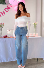 Full length view of mid-wash denim straight leg jeans with scattered rhinestone embellishments