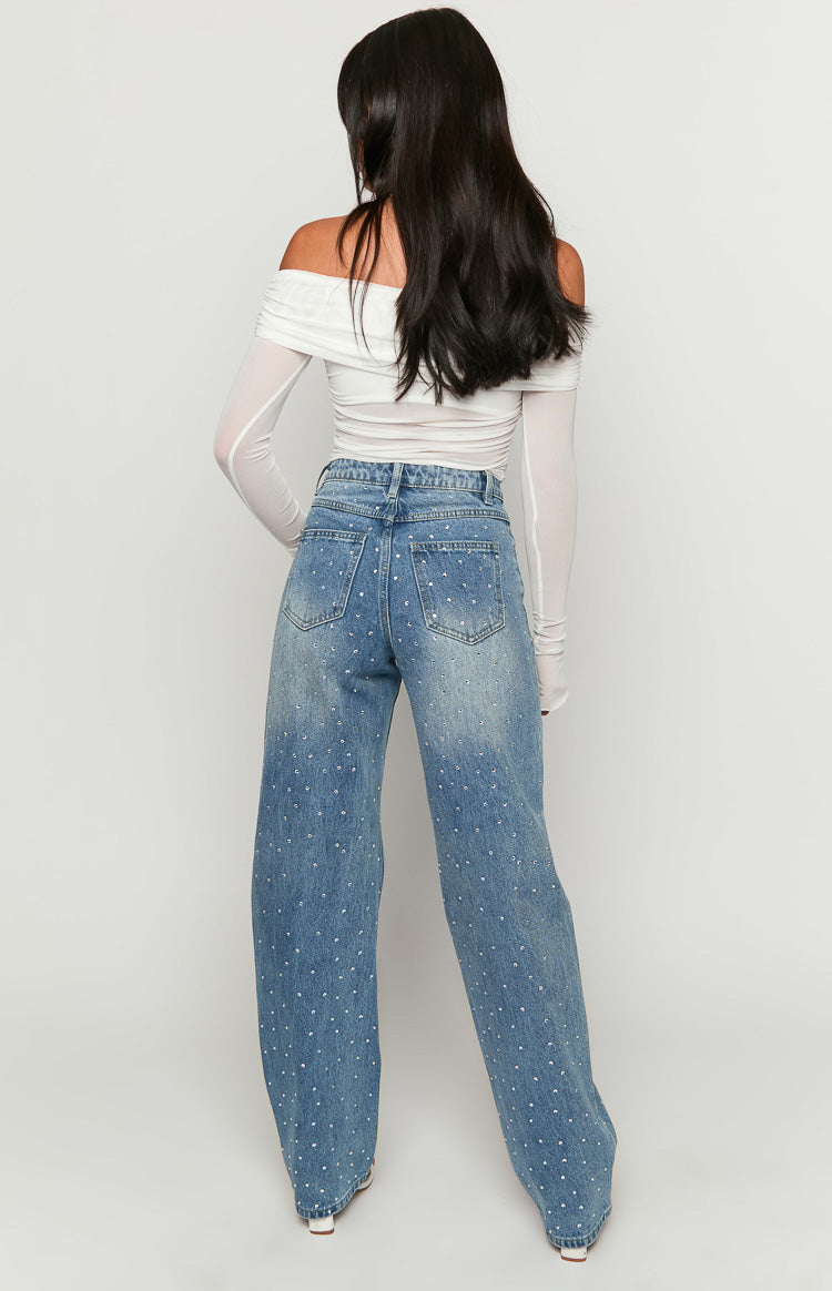 Rear view of mid wash denim straight leg jeans with scattered rhinestone embellishments