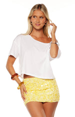 Front view of a yellow sequin mini skirt with overlapping round sequins creating a textured finish