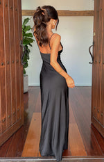Rear-side view of a black satin maxi dress with thin spaghetti straps and a low scoop back