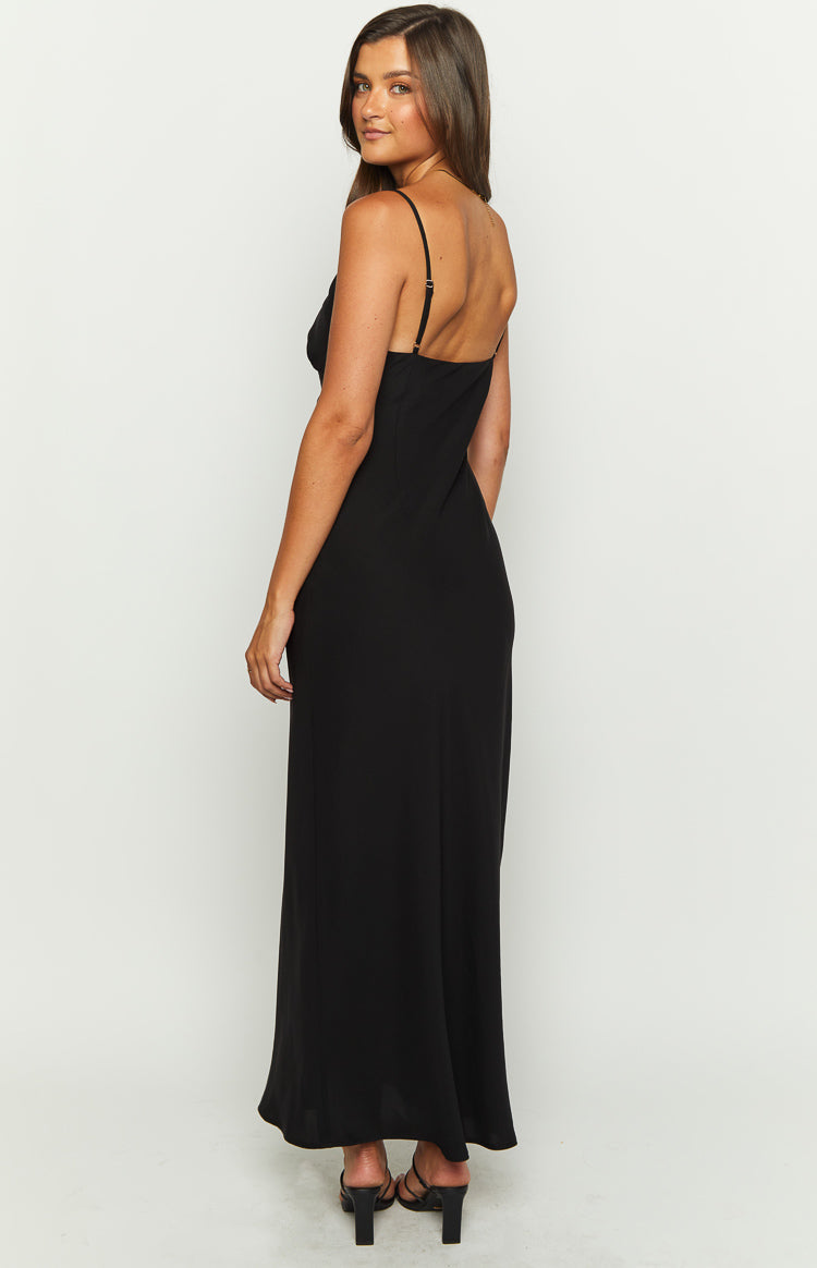 Close-up of the black maxi dress showing the V-neckline with delicate lace trim and a tie detail at the bust