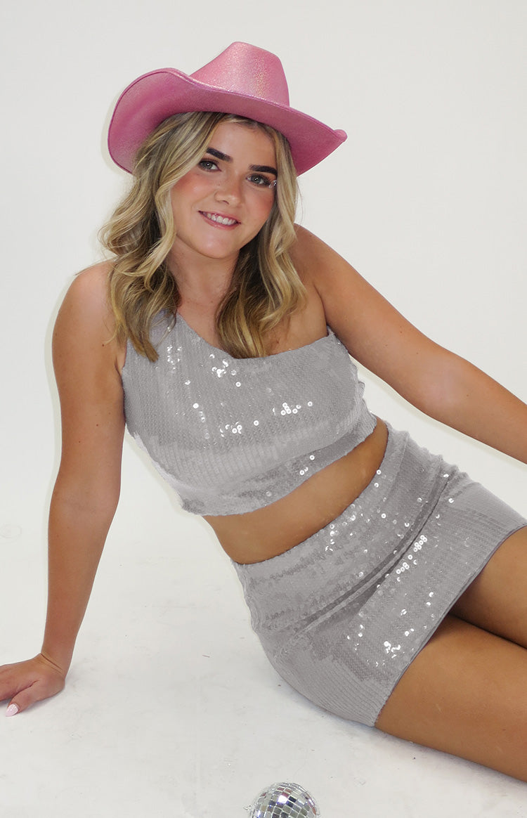 Silver sequin crop top featuring a one-shoulder neckline